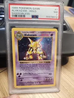 1999 POKEMON GAME SHADOWLESS #1 ALAKAZAM-HOLO PSA 7 - Image 1