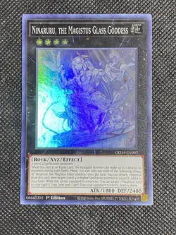 YuGiOh! - Ninaruru, the Magistus Glass Goddess GEIM-EN007 Super Rare 1st Edition - Image 1