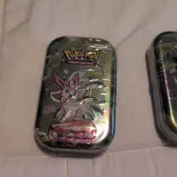 PRISMATIC EVOLUTIONS MINI TIN - FACTORY SEALED 1 - RANDOM ART - POKEMON TCG (1) - Image 1