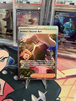 POKEMON JANINE’S SECRET ART SIR 173/131 SV: PRISMATIC EVOLUTIONS HOLO NM - Image 1