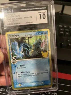 Pokemon TCG Mimikyu SWSH136 Delta Species Celebrations Black Star Promo Holo - Image 1