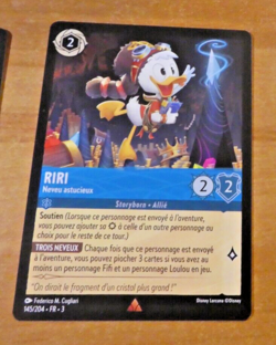 LORCANA CARD RARE GAME TCG DISNEY CHAPITRE 3 CARTE RIRI 145/204 FR TCG NEUF - Image 1