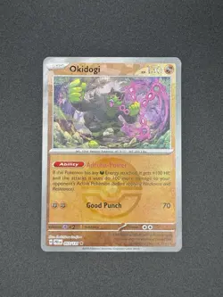 Pokemon Prismatic Evolutions OKIDOGI Reverse Holo Pokeball 057/131 - Image 1