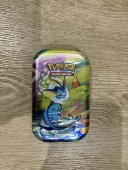 Pokemon TCG: Scarlet & Violet - Prismatic Evolutions Mini Tin - Vaporeon - Image 1