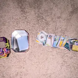 Pokemon cards with sleeves and tin - Image 1