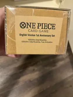 One Piece TCG English 1st Anniversary Set Promo Cards, Playmat Sleeves, Sealed - Image 1