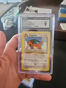 CGC 9 - 1999 Dragonite # 5 WB Movie WOTC Black Star PROMO Pokemon Card - Image 1