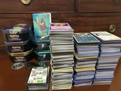 Bulk Pokemon cards. Holo cards. Code cards. Empty Tins, coins, And a Mini binder - Image 1