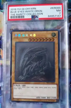 PSA 7 Yugioh Blue-Eyes White Dragon TRC1-KR000 Ghost Rarity Collection Korean - Image 1