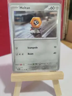 Meltan - 102/142 SV07: Stellar Crown 102/142 Yuka Mori Clay Art Pokemon Card - Image 1