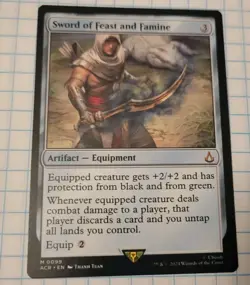 MTG Sword of Feast and Famine - Assassin's Creed Regular 99 M ACR - Image 1
