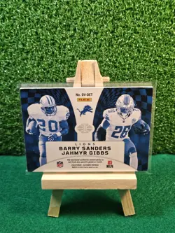 2024 Panini Illusions - Deja Vu Barry Sanders, Jahmyr Gibbs #DV-DET /199 (MEM) - Image 2