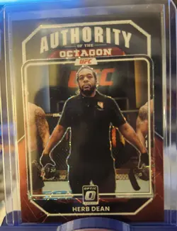 2023 Donruss Optic UFC Herb Dean Authority of the Octagon #'d 3/39 - Image 1