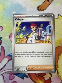 Crispin 105/131, 133/142 Pokemon Prismatic Evolutions/Stellar Crown Trainer NM - Image 1