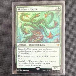 Wizards of the Coast MTG Mossborn Hydra Foundations Rare 0107 0/0 Regular Green - Image 1