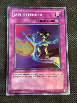 YuGiOh! - Jam Defender RP02-EN036 Super Rare Unlimited (Reprint) Near Mint - Image 1