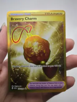 Bravery Charm 175/142 Gold Hyper Rare 2024 Pokemon Stellar Crown Card NM - Image 1