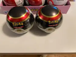 Lot of 2 - D21 Pokemon Tins, Cosmic Eclipse, Rebel Clash, And Vivid Voltage - Image 1