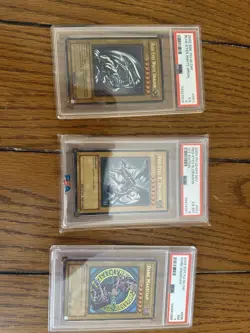 PSA 7, 6, 5 Blue Eyes White Dragon, Dark Magician, And Red Eyes B. Dragon 1st Ed - Image 1
