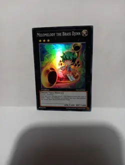 Yu-Gi-Oh! TCG Melomelody the Brass Djinn Xyz Symphony YS12-EN042 Ist Ed Super Ra - Image 1