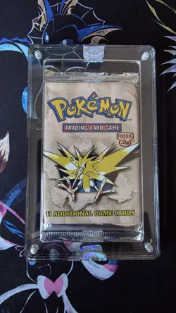 1999 POKEMON FOSSIL BOOSTER PACK ZAPDOS IN SEALED ACRYLIC CASE VINTAGE - Image 1