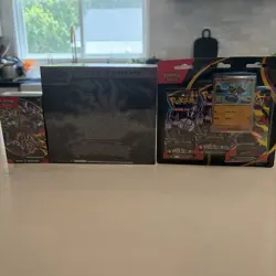Pokemon Pitch Black ETB, Booster Bundle, and 3 Pack Blister in hand - Image 1