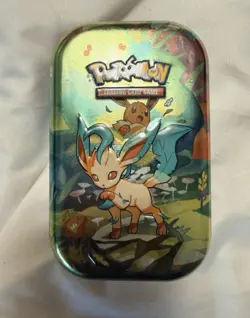 Pokemon Prismatic Evolutions Mini Tin Leafeon & Eevee Collectable Art Card Coin - Image 1