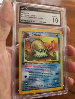 CGC 10 GEM MINT Omanyte Fossil 1st Edition Pokemon WOTC Card 52/62 1999 - Image 1