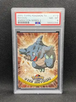 56553356 2000 Pokemon Topps TV Animation Series 2 Rhydon #112 PSA 8 - Image 1