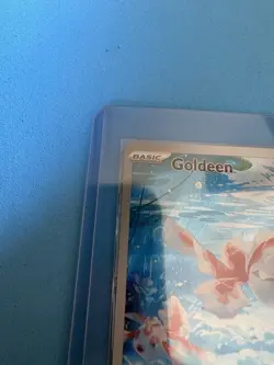 Goldeen 087/084 Illustration Rare Holo Pitch Black Pokemon Card in Hand - Image 2