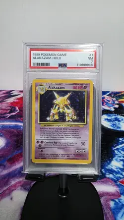 1999 POKEMON BASE SET UNLIMITED #1 ALAKAZAM-HOLO PSA 7 - Image 1