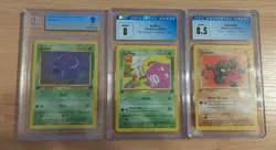 Three graded Pokemon cards (Zubat, Geodude, Koffing) - Image 1