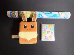 Prismatic Evolutions SPC Play Mat, Eevee Deck Box, Card Sleeves - Image 1