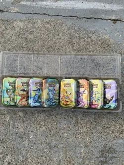BRAND NEW Pokemon Prismatic Evolutions | Empty Mini Tins With Coins And Art Card - Image 1