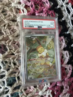 2025 POKEMON PRISMATIC EVOLUTIONS POKEMON CENTER ETB PROMO #173 EEVEE PSA 9 - Image 1