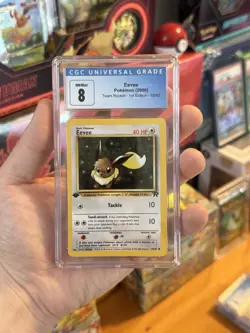 Eevee 1st Edition Team Rocket CGC 8 NM/M Pokemon TCG - Image 1
