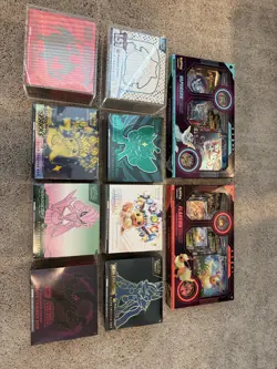 7 Pokemon Center ETB's + 1 ETB (Tear in Plastic) + 2 VMAX Boxes - Image 2