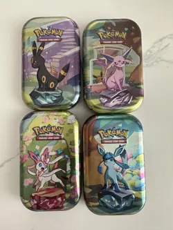 Pokemon Prismatic Evolutions EMPTY! Mini Tin Set Of 4 (Tin + Card + Coin) - Image 1