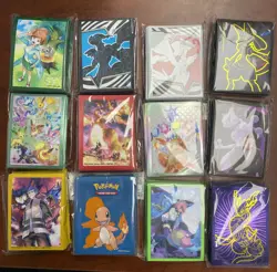 Lot of 12 Assorted Pokemon Sealed ETB Card Sleeves With Tin - Image 1