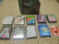 Pokemon Card Sleeve Lot featuring MEW, PRE, & more + EMPTY great tusk tin - Image 1