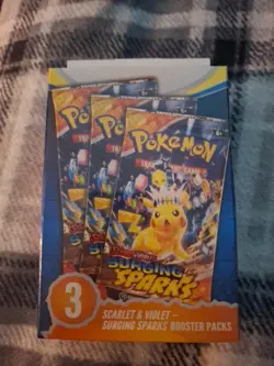 Pokemon TCG Surging Sparks Booster Bundle Sealed with 3 Pokemon Packs - Image 1