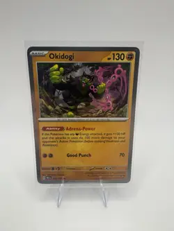 Okidogi 057/131 Holo Rare Prismatic Evolutions NM Pokemon TCG Card - Image 1
