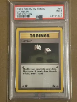1999 POKEMON FOSSIL 1ST ED #60 GAMBLER PSA 9 - Image 1