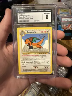 1999 Pokemon Dragonite Black Star Movie Promo 5 CGC 8 *minor scratches - Image 1