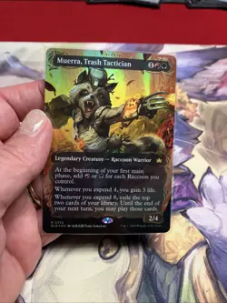 Muerra, Trash Tactician (Borderless) (Raised Foil) Bloomburrow Foil - Image 1