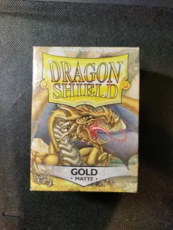 (100-Pack) Dragon Shield Standard Size Gaming Card Sleeves - GOLD MATTE - Image 1