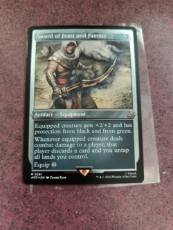 MTG Sword of Feast and Famine (Foil Etched) [Assassin Creed] Magic the Gathering - Image 1