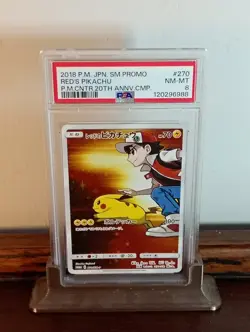 Red's Pikachu Japanese 20th Anniversary Pokemon Card SM-P 270 - PSA Near Mint 8 - Image 1