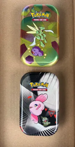 2 Pokemon tine filled with Pokemon cards! & a free Once Piece tin w/ OP cards - Image 1