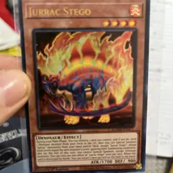 Jurrac Stego BLMM-EN017 1st Edition Holo YuGiOh Card - Image 1